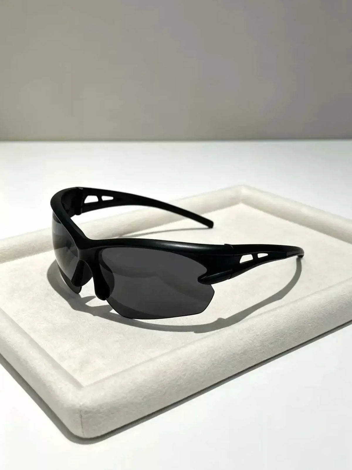 UV Protective Tinted Sunglasses displayed on a soft white surface with a modern design.