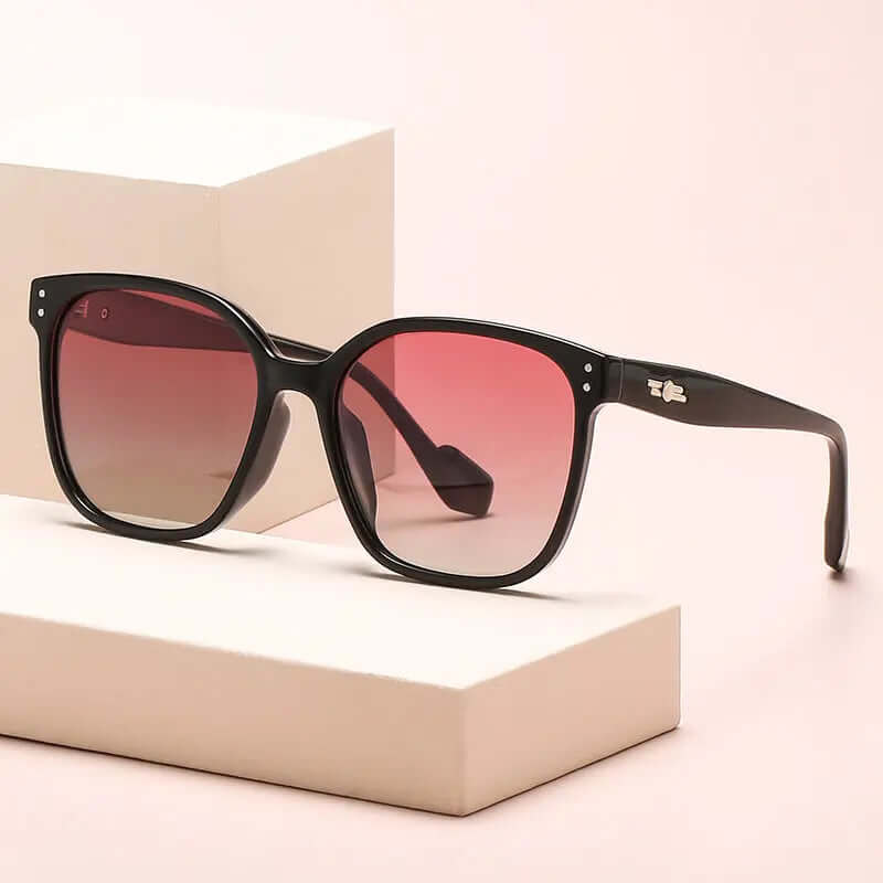 Oversized Gradient Lens Sunglasses displayed on a soft background, showcasing gradient pink lenses and a stylish black frame.