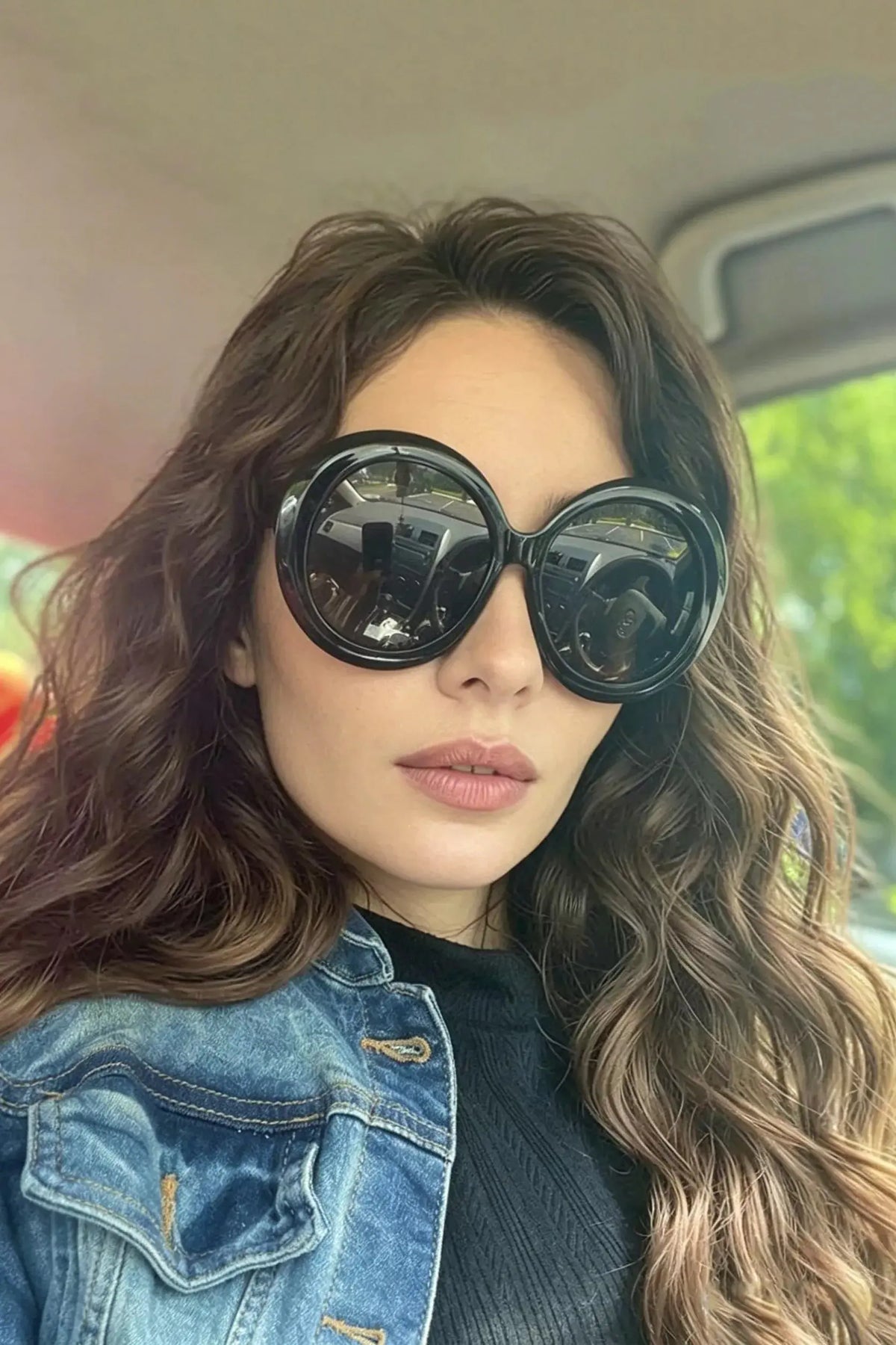 Oversized Round Frame Fashion Sunglasses being worn by a woman with curly hair and a denim jacket.