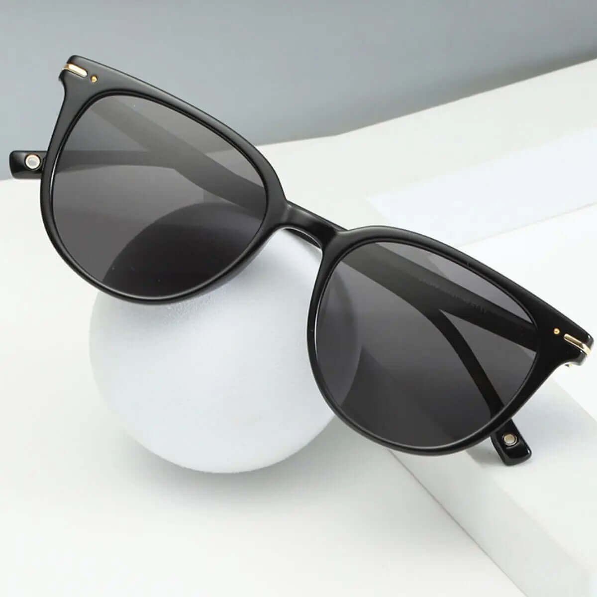 Stylish UV Protection Sunglasses with Polycarbonate lenses and black frame on a white surface.