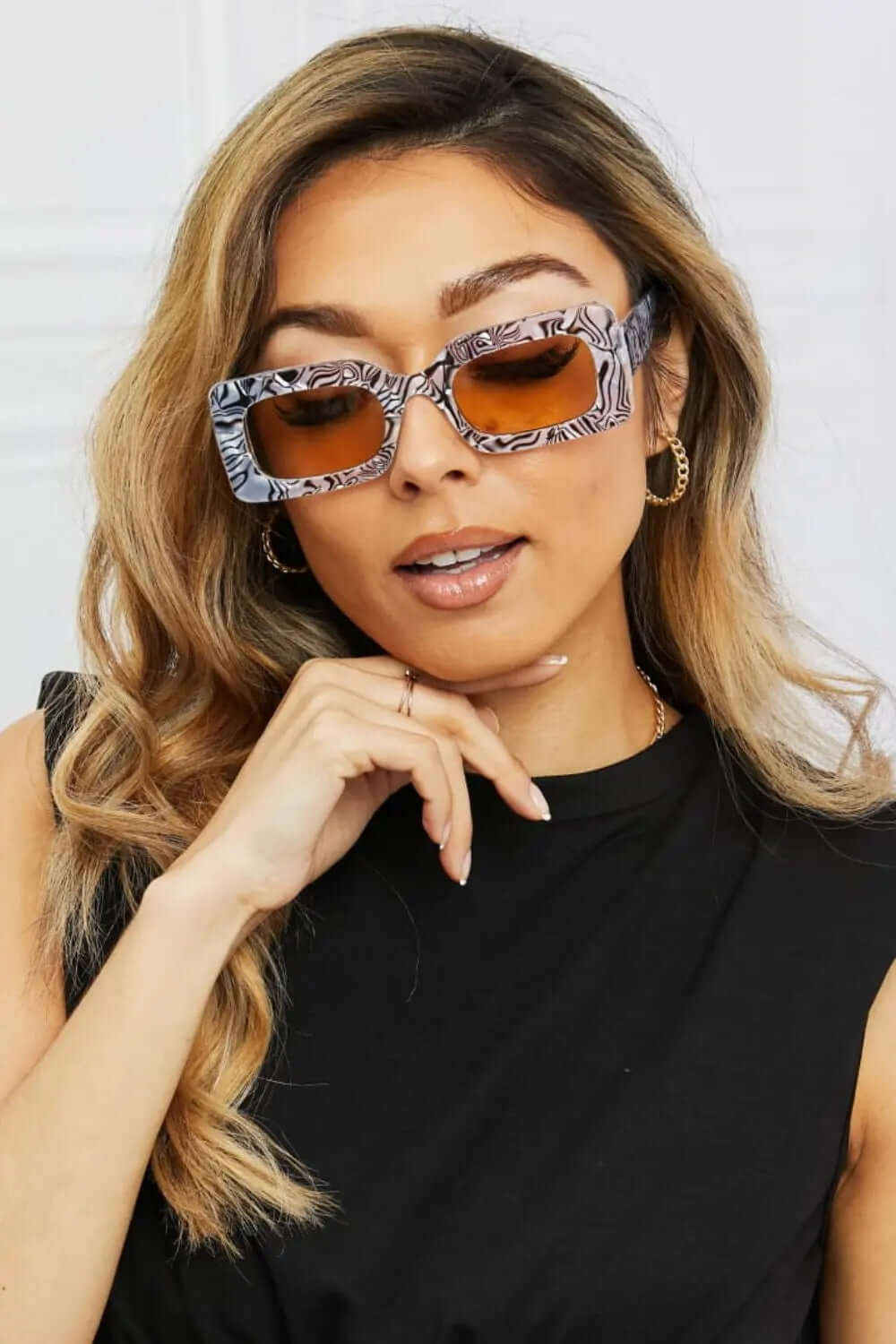 Tortoiseshell Rectangle Polycarbonate Sunglasses showcased on a model with stylish hair and accessories.