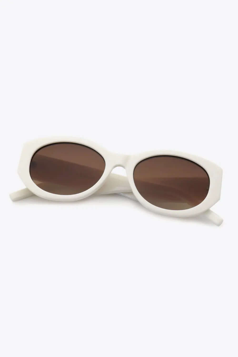 Stylish UV400 Polycarbonate Sunglasses with brown lenses in an oval frame.