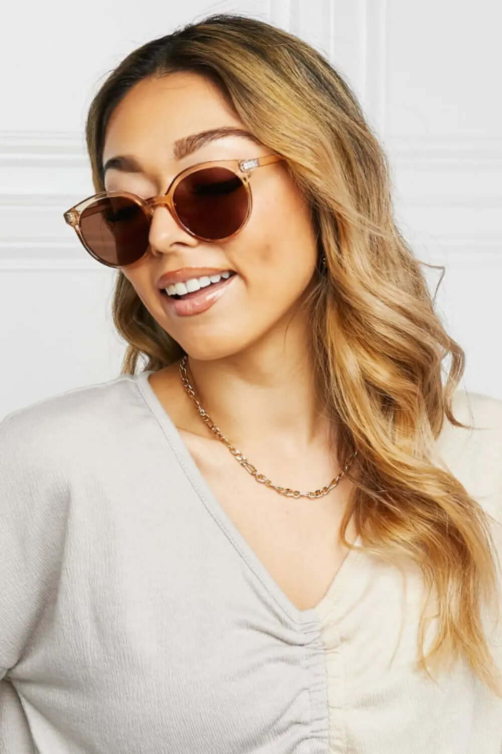 Round Full Rim Polycarbonate Frame Sunglasses worn by a woman with long hair and a beige top.