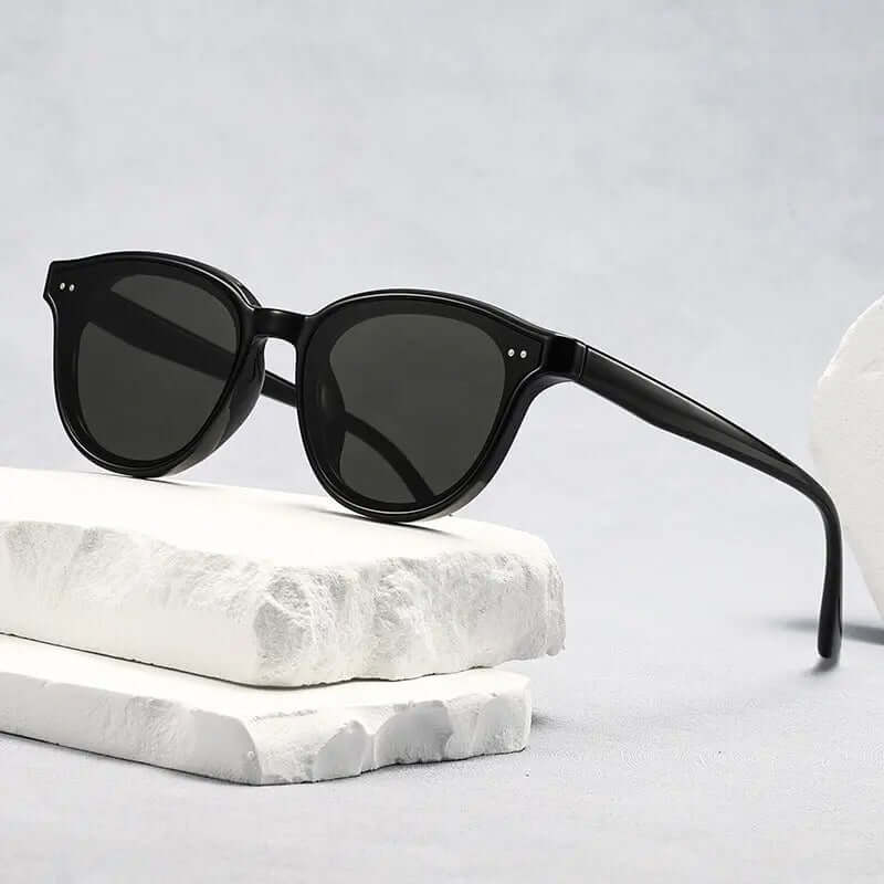 Classic UV Protection Sunglasses on a stone surface with a modern design and UV400 protection.