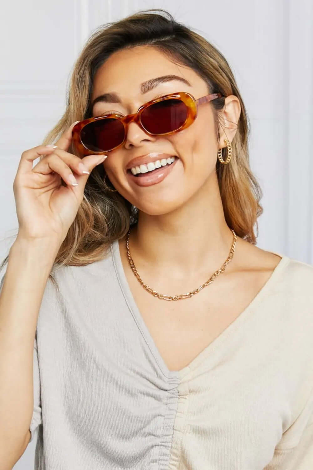 Oval Full Rim Sunglasses worn by a smiling woman, showcasing a stylish and trendy look.