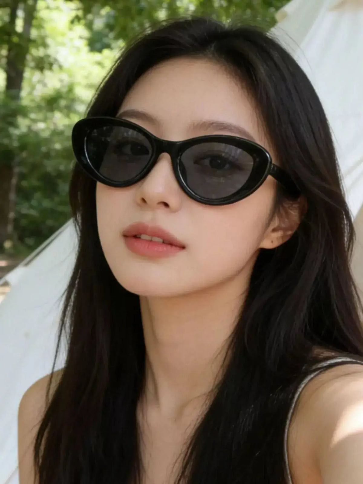 Cat Eye Sunglasses model wearing UV400 polycarbonate sunglasses outdoors.