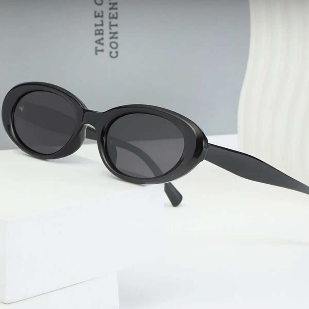 UV Protection Oval Sunglasses featuring a sleek black design and UV400 protection for stylish sun safety.